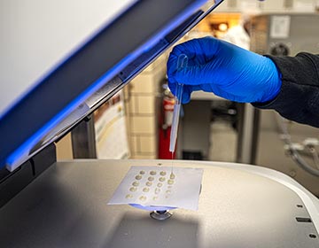 close up on Lab tech using machine