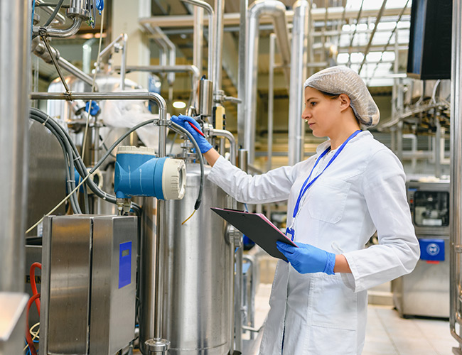 Female engineer working on maintenance in bottling plant